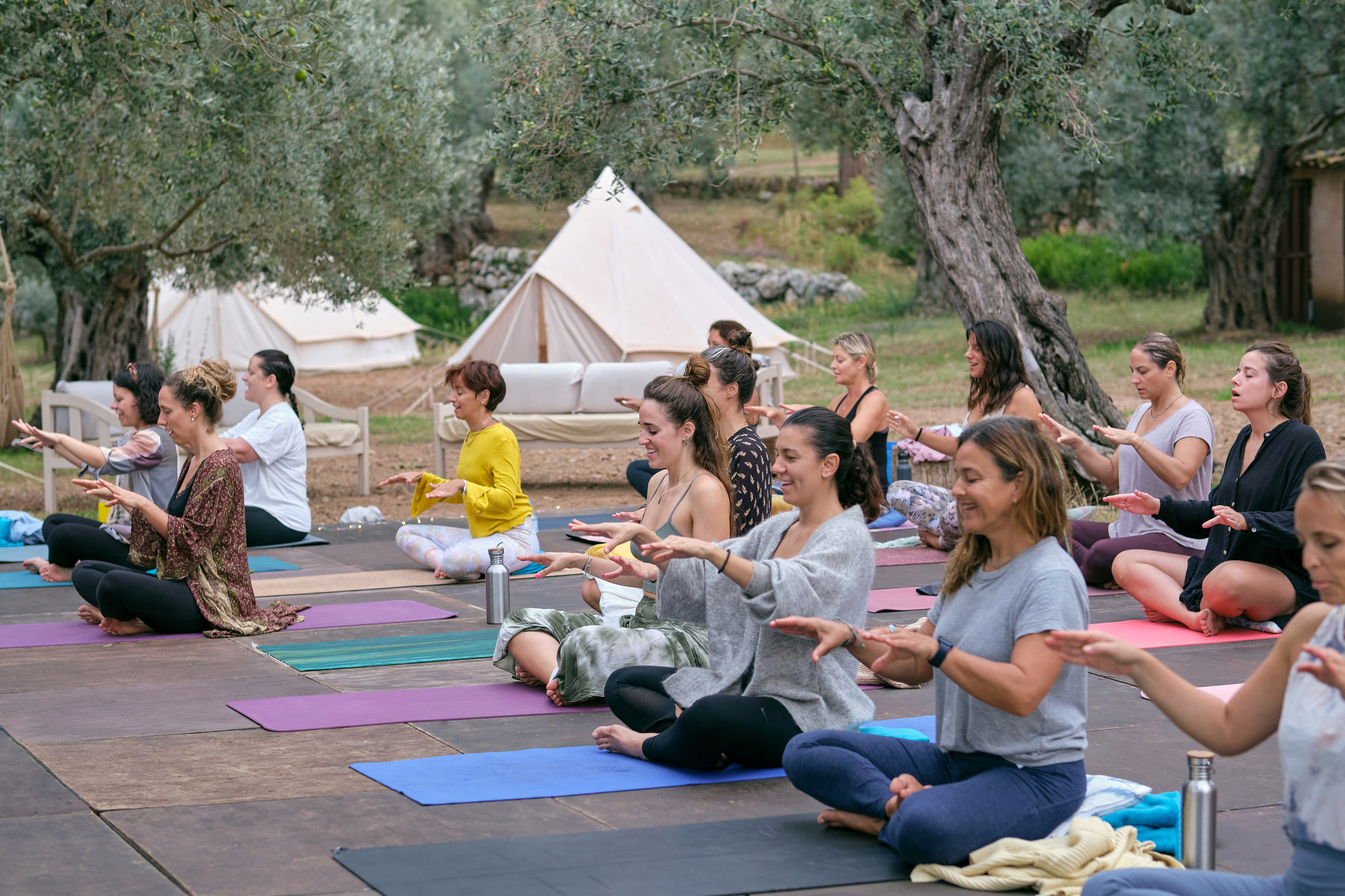 Women training yoga in campsite